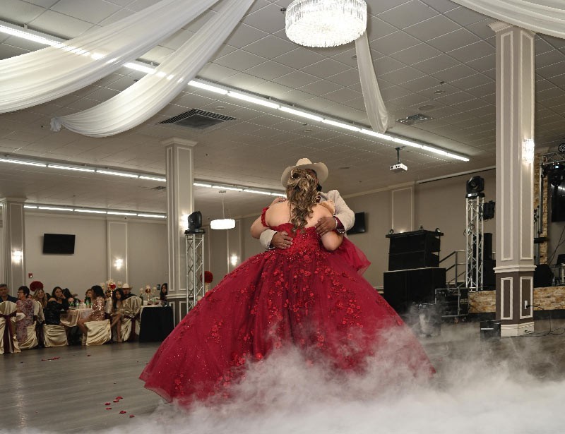 Garcia event centers quinceanera with people dancing below chandelier